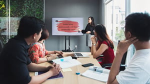 A team meeting with a girl presenting
