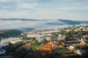 A hill surrounded by cloud, under the morning sun