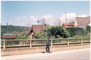 Boy walking across a bridge