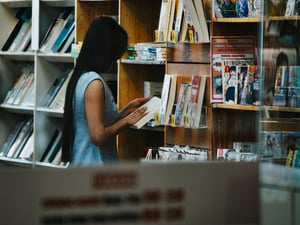 A girl reading a book in a book-store