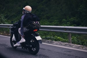 A couple driving on a motorbike