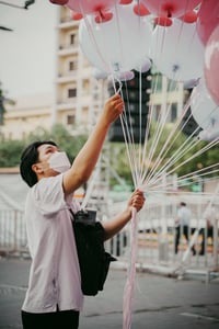 Man Holding Balloons