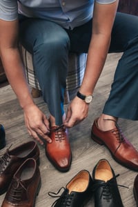 A gentleman trying on a pair of shoes