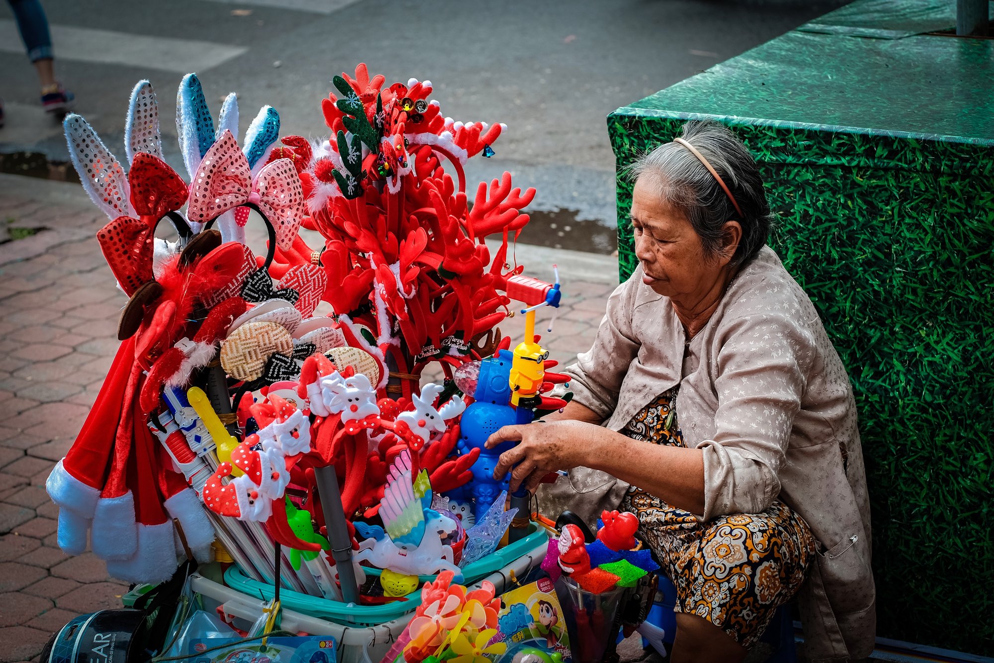 An old lady selling toys on the street