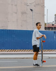 Boy standing with skateboard