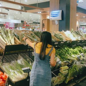 A girl shopping for vegetables in supermarket