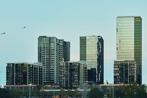 Reflective skyscrappers over the horizon, with kites flying above