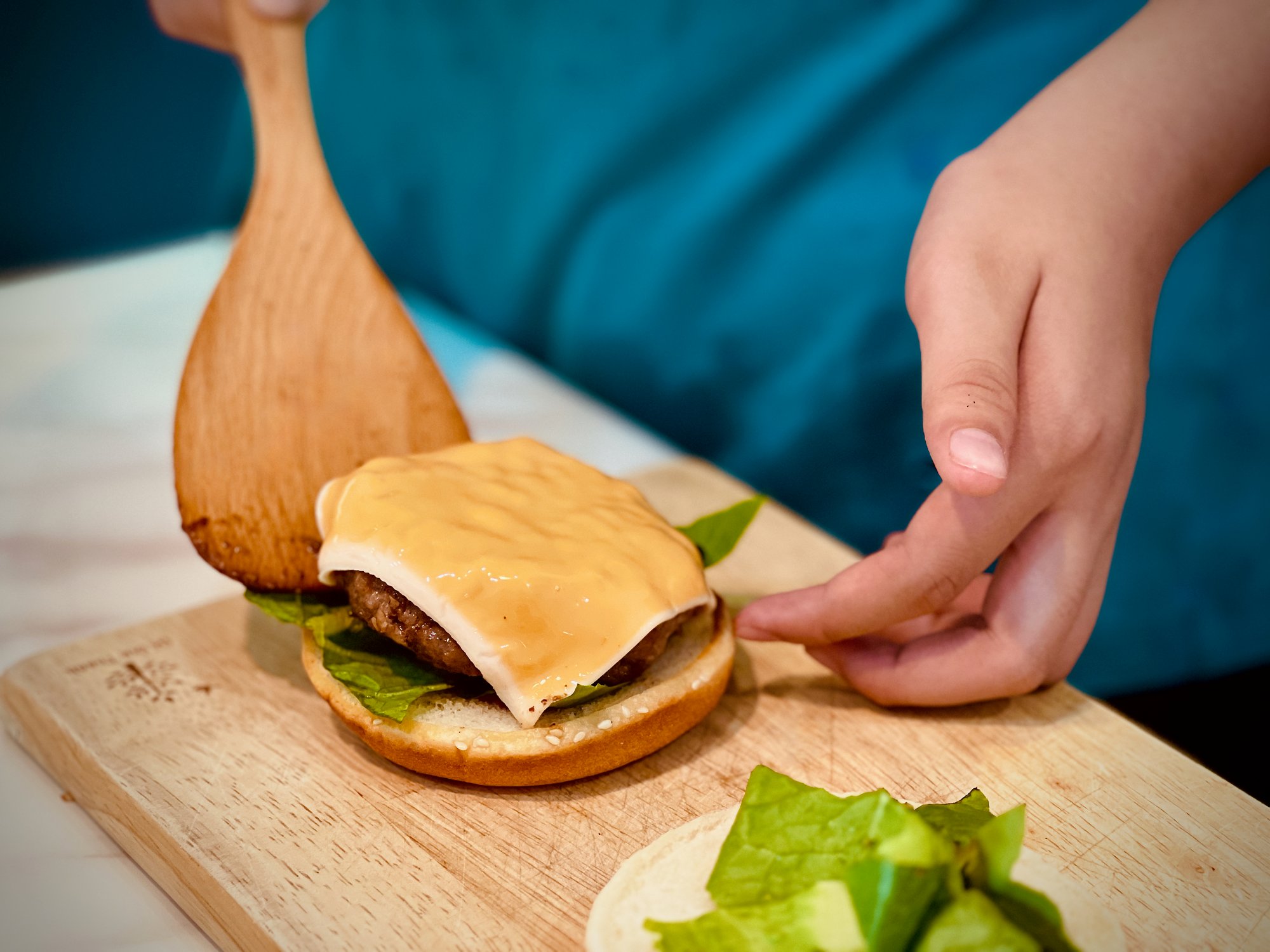 A cook serving a burger