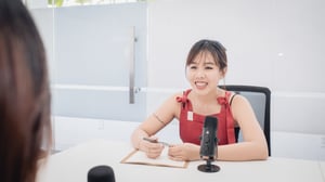 Asian girl recording a podcast