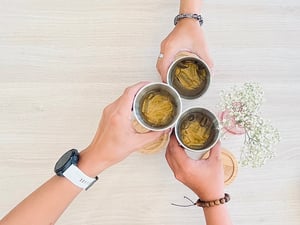Three hands holding and cheers with iced tea cup