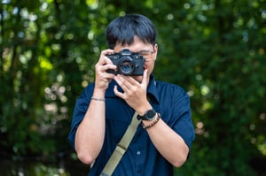 A Nikon Photographer in blue T-shirt