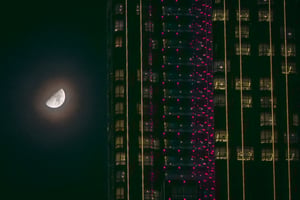 Moon next to an office building