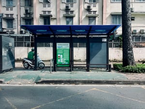 A Grab driver waiting behind a bus shelfter