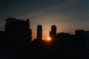 Beautiful sun setting behind high rise apartment towers