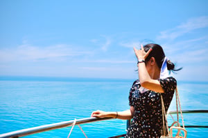 Girl greeting wind and sea