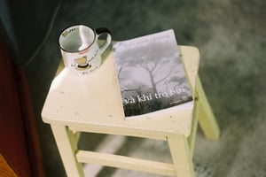 High angle view of a book and mug on a small wooden stool