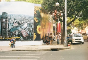 Daily life in Ho Chi Minh City with street vendors, local commuters and a Vinasun taxi
