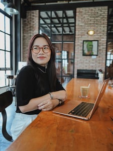 A creative-looking girl is working on a laptop