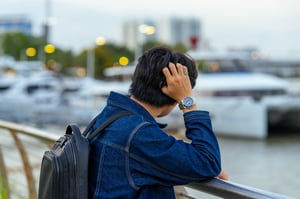Man looking afar with his Rolex watch