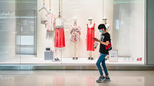 A customer passing by a H&M store