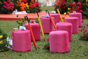 Colorful umbrellas and stools at a wedding