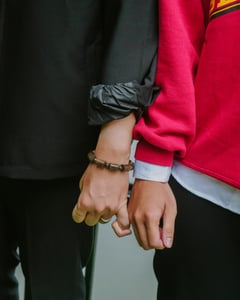 Two men holding hands