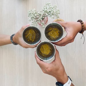 Three hands holding and cheers with iced tea cup