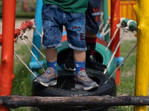Kids running over tires in colorful playground