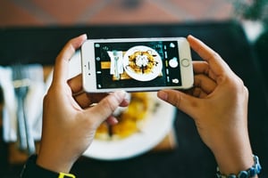 Taking food photo with Iphone in a restaurant