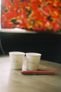 Two paper coffee cups with handwritten names