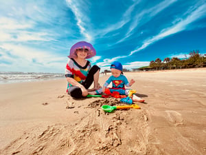 A grandmother with her grandson playing on the beach