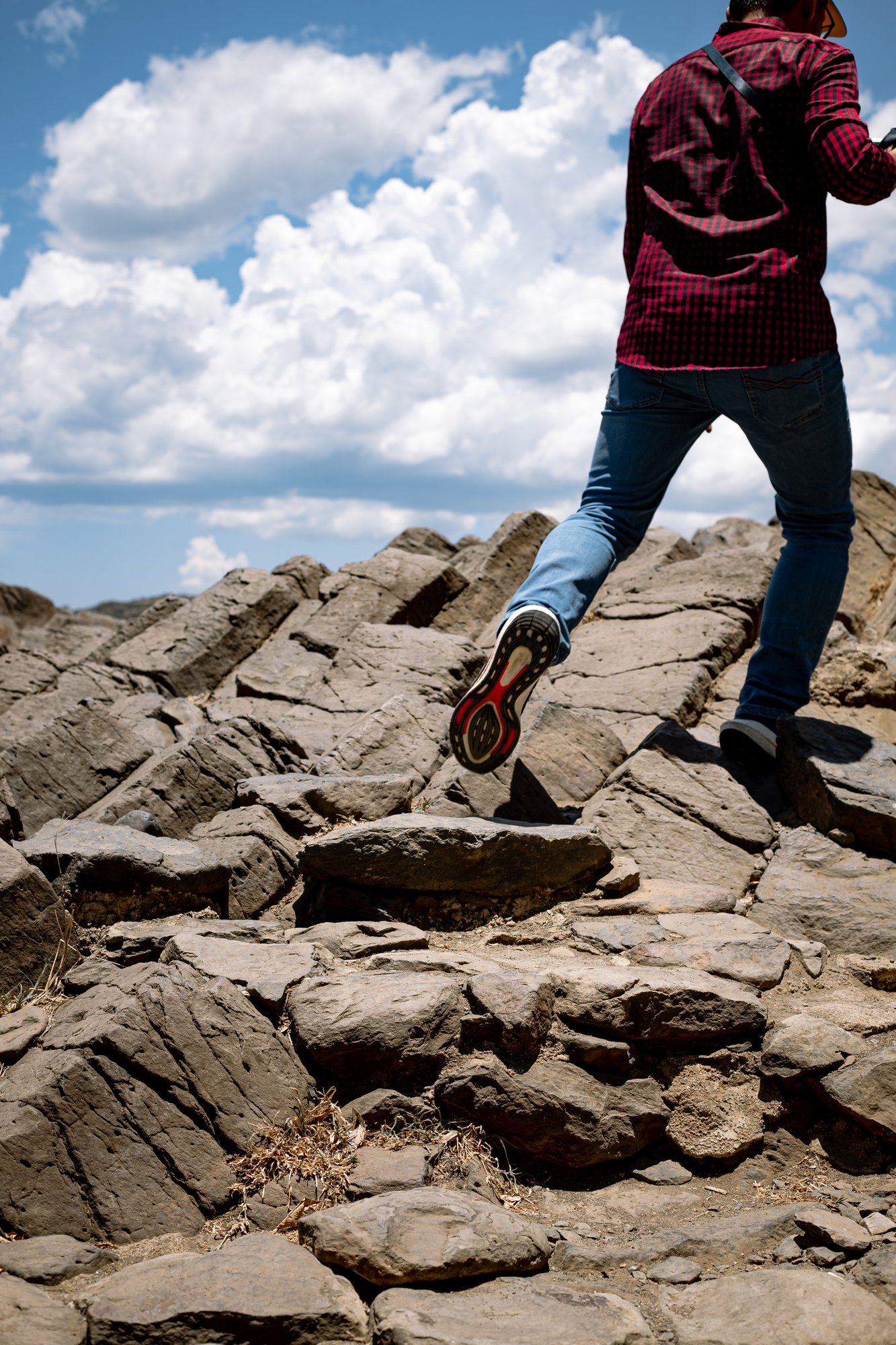 A man running up a rock stone hill