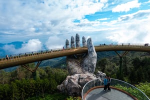 Couple posing on the Golden Bridge, Ba Na Hills