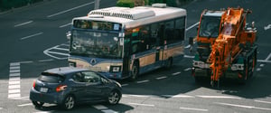 Bus, car and crane truck on the road