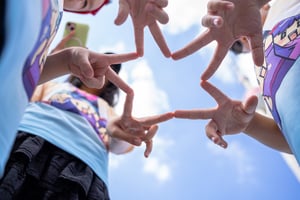 Kids forming a star with hands