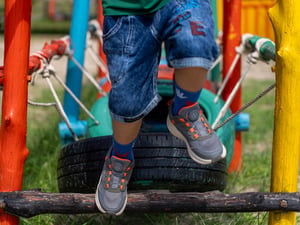 Kids running over tires in colorful playground