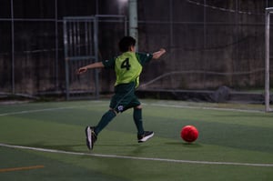 A boy dribbling a ball