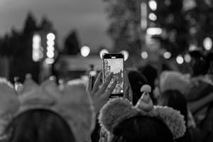 Mickey Girl recording videos of a parade