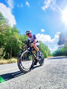 Man riding bicycle under sunlight