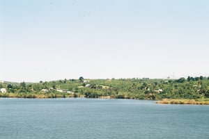 Countryside lake panorama surrounded by green mountains