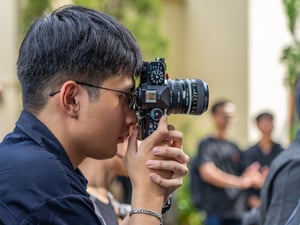A photographer with his classic Nikon