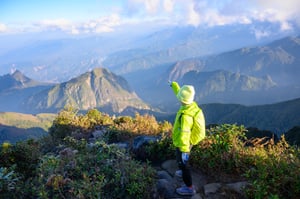 A trekker pointing the trail ahead