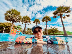 A happy colorful girl in the pool