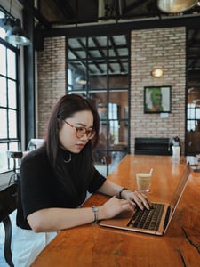 A creative-looking girl is working on a laptop