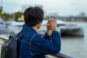 Man looking afar with his Rolex watch