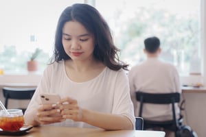 Woman with a smile holding smartphone