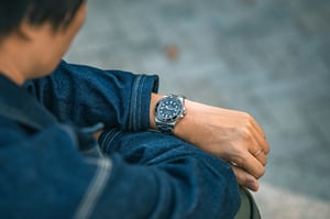 Man looking at his hard-earned Rolex Luxury Watch