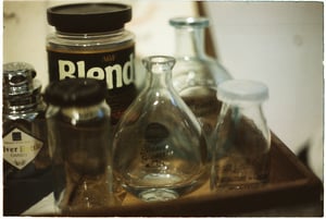Vintage glass bottles on a rustic wooden tray