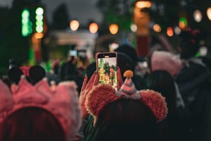 Mickey Girl recording videos of a parade
