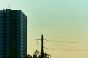 A commercial airplane fly-by during a vibrant sunset in Ho Chi Minh City